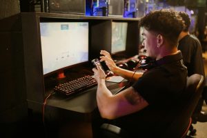 A man in a black shirt testing a mobile phone for gaming